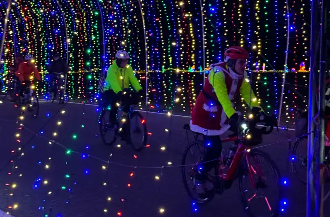 Holiday Bike Riders in Winter Wonderland's Light Tunnel