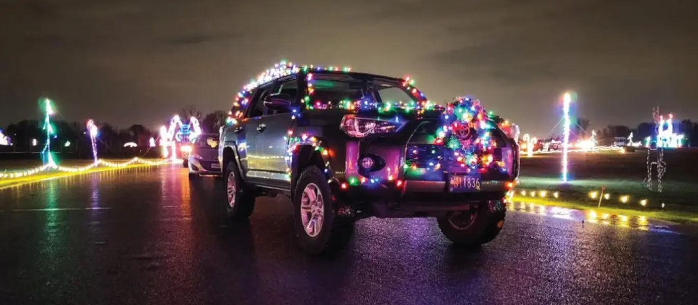 Toyota 4-Runner With Christmas Lights Driving Through Winter Wonderland